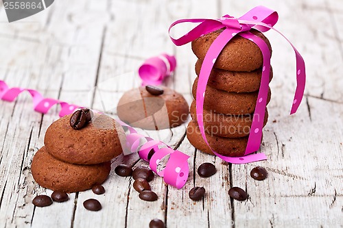 Image of stack of chocolate cookies tied with pink ribbon and coffee bean