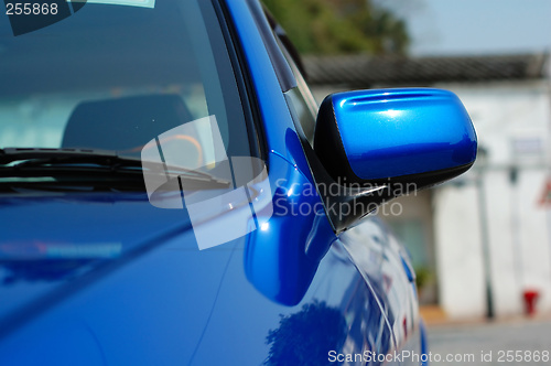Image of Right side mirror of shiny blue car