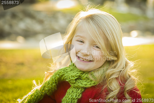 Image of Little Girl Wearing Winter Coat and Scarf at the Park
