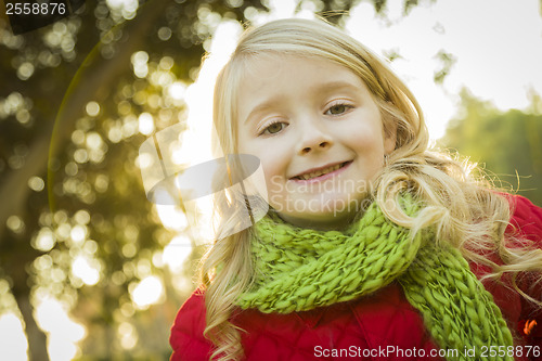 Image of Little Girl Wearing Winter Coat and Scarf at the Park
