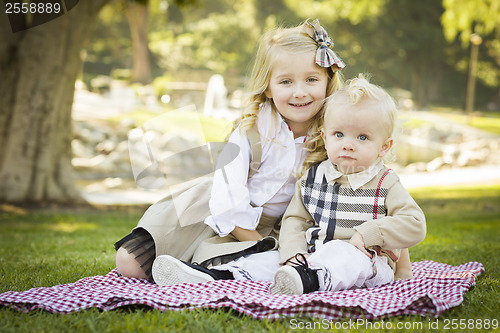 Image of Sweet Little Girl with Her Baby Brother at the Park
