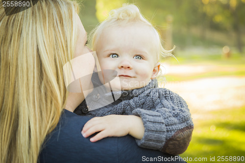 Image of Mother Embracing Her Adorable Blonde Baby Boy
