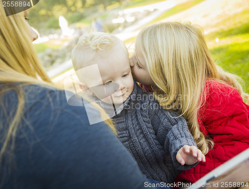 Image of Mother Reading a Book to Her Two Adorable Blonde Children
