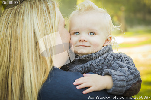 Image of Mother Embracing Her Adorable Blonde Baby Boy
