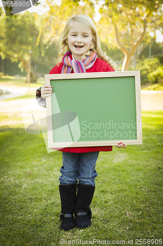 Image of Cute Girl Holding a Green Chalkboard Wearing Winter Coat Outdoor