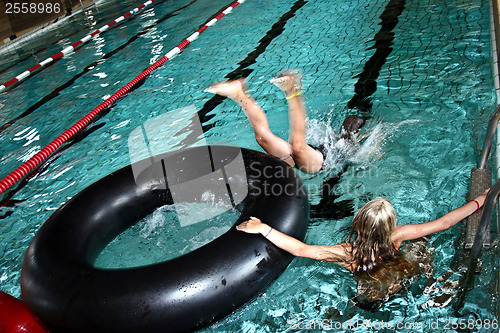 Image of Girls at the pool with a buoy