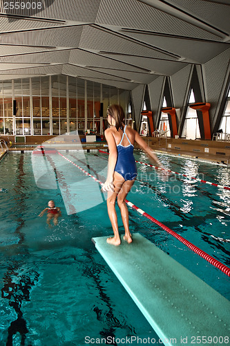 Image of Girl jumpimg at the pool