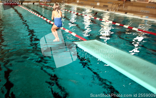 Image of Girl jumpimg at the pool