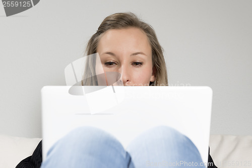 Image of woman on sofa with laptop