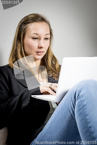 Image of woman on sofa with laptop