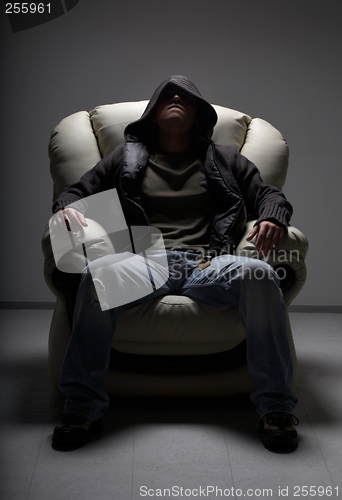 Image of dangerous man sitting in white chair