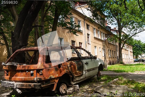 Image of Residental house and burned-down vehicle