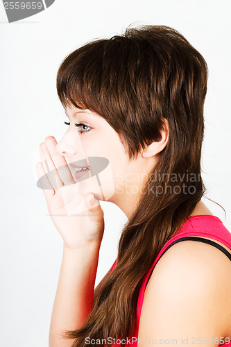 Image of Young attractive girl whispering