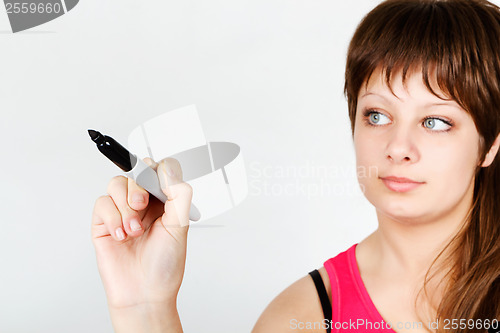 Image of Young attractive girl writing in marker