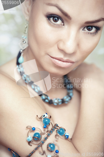 Image of Woman with blue jewelry