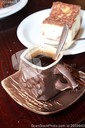 Image of cup of coffee and portion of cake