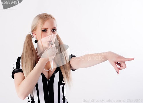 Image of Football referee whistling and pointing to side