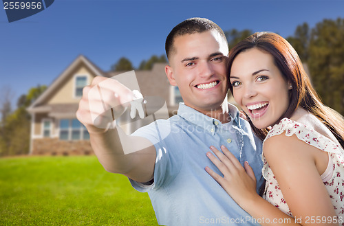 Image of Military Couple with House Keys In Front of New Home