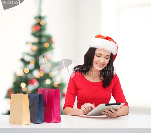 Image of woman with shopping bags and tablet pc computer