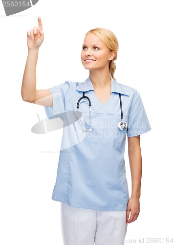 Image of smiling doctor or nurse pointing to something