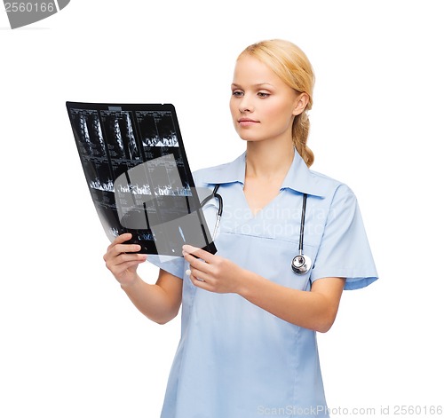 Image of serious doctor or nurse looking at x-ray