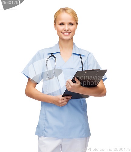 Image of smiling female doctor or nurse with clipboard