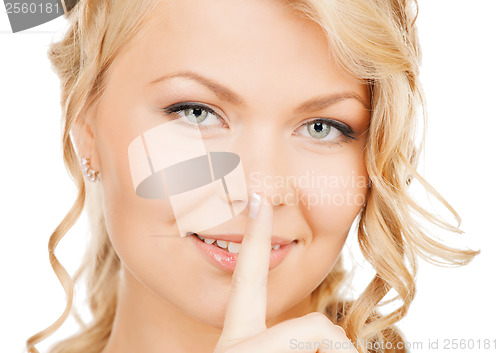 Image of woman with finger on her lips