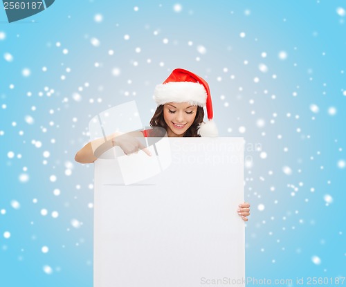 Image of woman in santa helper hat with blank white board