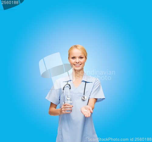 Image of smiling doctor or nurse offering pills and water