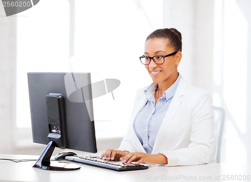 Image of african businesswoman with computer in office