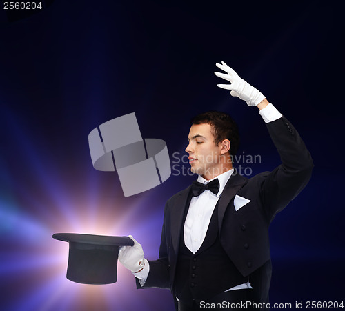 Image of magician in top hat showing trick