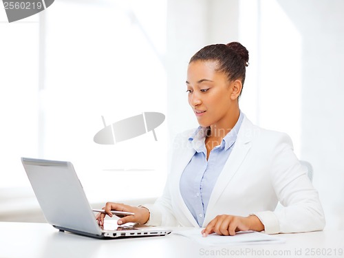 Image of african businesswoman writing something