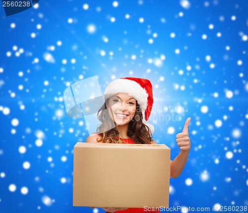 Image of smiling woman in santa helper hat with parcel box