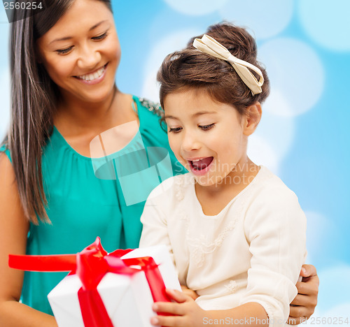 Image of happy mother and child girl with gift box