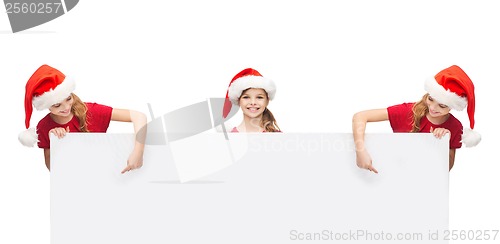 Image of girls in santa helper hats with blank white board