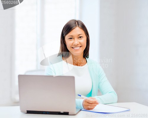Image of asian businesswoman with laptop and documents
