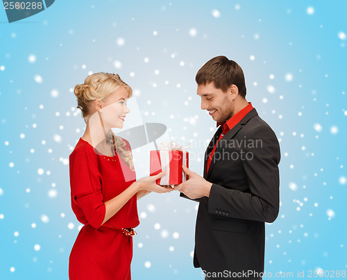 Image of smiling woman and man with gift box