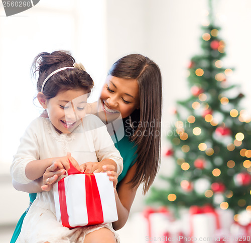 Image of happy mother and child girl with gift box