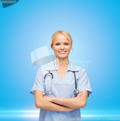 Image of female doctor or nurse in mask holding syringe