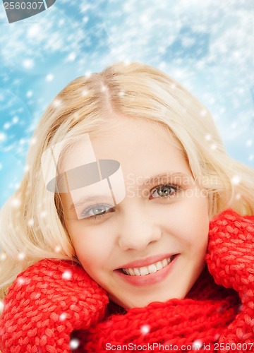 Image of smiling teenage girl in red mittens and scarf