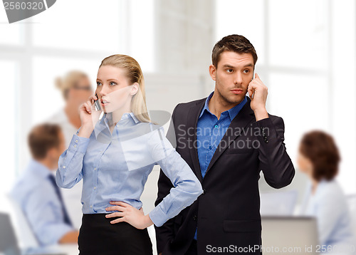 Image of woman and man with cell phones calling