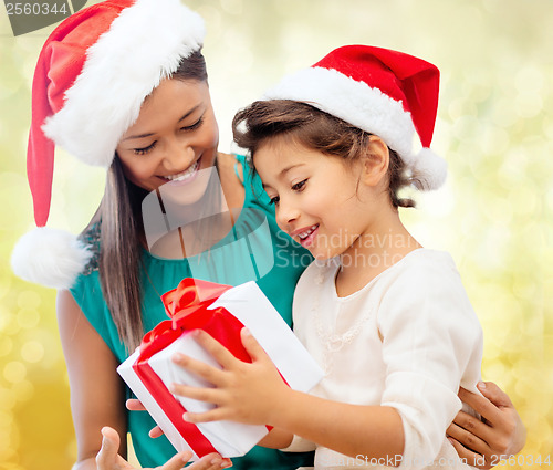 Image of happy mother and child girl with gift box