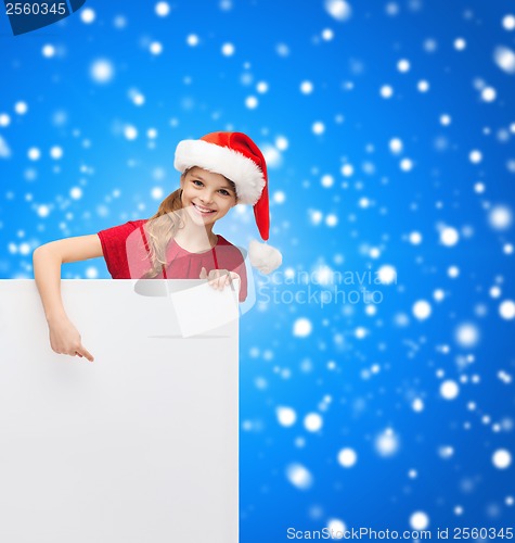 Image of child in santa helper hat with blank white board