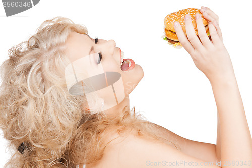 Image of beautiful happy woman with burger
