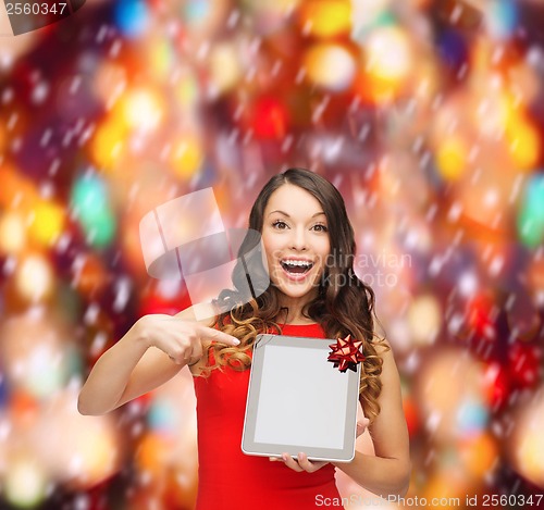 Image of smiling woman in red dress with tablet pc