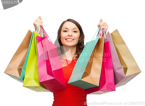 Image of woman in red dress with colorful shopping bags