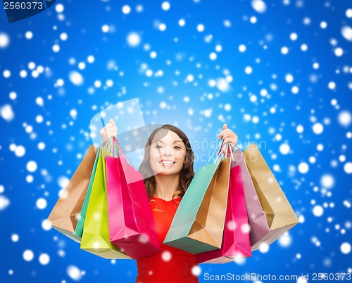 Image of woman in red dress with colorful shopping bags
