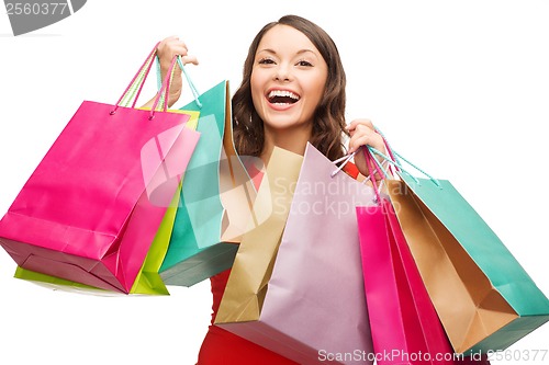 Image of woman in red dress with colorful shopping bags