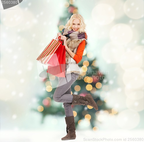 Image of teenage girl in winter clothes with shopping bags