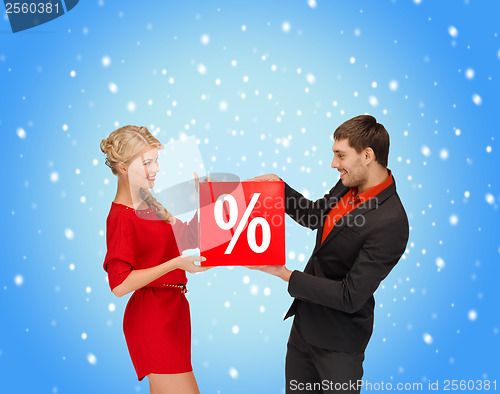 Image of smiling woman and man with red percent sale sign